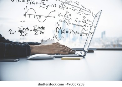 Side view of male hands using laptop with abstract mathematical formulas. Online education concept - Powered by Shutterstock