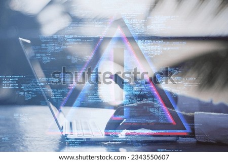 Side view of male hands using laptop at desktop with exclamation mark hologram on blurry background. Hacking, malware and technology concept. Double exposure