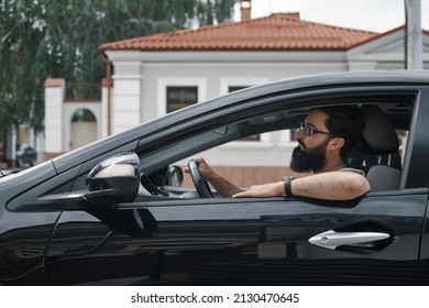 Side view man driving to work through the city