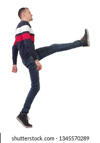 Side View Man Funny Fights Waving His Arms And Legs. Isolated Over White Background. The Guy In The Sweater Swung His Foot.