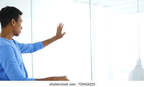 Side View of Man Looking through Office, Hands on Office Glass Wall