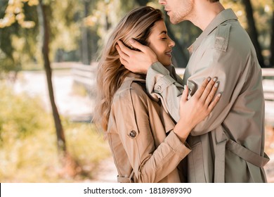 Side View Of Man Touching Hair Of Woman With Closed Eyes Outside