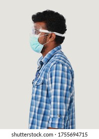 Side View Of A Man Wearing Mask And Safety Goggles  For The Protection Against Virus.