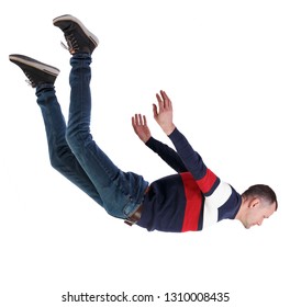 Side View Of Man In Zero Gravity Or A Fall. Guy Is Flying, Falling Or Floating In The Air.  Side View Of Person.  Isolated Over White Background. A Man In A Striped Sweater Falls Head Down.