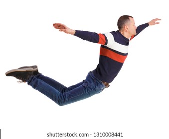 Side View Of Man In Zero Gravity Or A Fall. Guy Is Flying, Falling Or Floating In The Air. Isolated Over White Background. A Man In A Striped Sweater In A Horizontal Jump Or Flight.