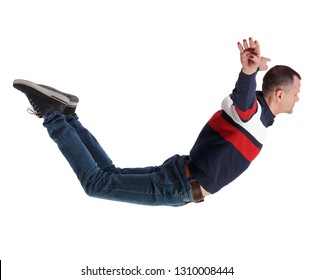 Side View Of Man In Zero Gravity Or A Fall. Guy Is Flying, Falling Or Floating In The Air.  Side View Of Person.  Isolated Over White Background. A Man In A Striped Sweater Falls Wide Apart.