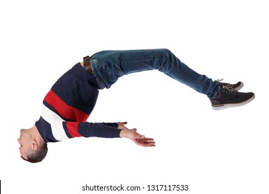 Side View Of Man In Zero Gravity Or A Fall. Guy Is Flying, Falling Or Floating In The Air.  Side View Of Person.  Isolated Over White Background. Stylish Guy In A Jacket Falls Back Down.