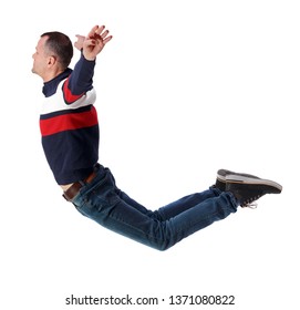 Side View Of Man In Zero Gravity Or A Fall. Guy Is Flying, Falling Or Floating In The Air.   Side View Of Person.  Isolated Over White Background. The Guy In Jeans Soars In The Air Or Water.