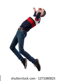 Side View Of Man In Zero Gravity Or A Fall. Guy Is Flying, Falling Or Floating In The Air.  A Man In A Striped Sweater Is Balancing On The Tips Of His Toes, Strongly Leaning Back.