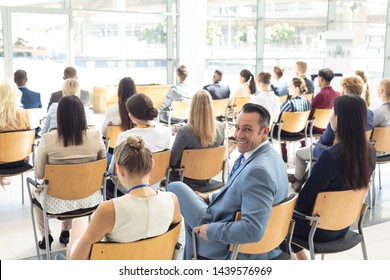 Side view of mature Caucasian male executive sat in conference room, smiling to camera - Shutterstock ID 1439576969