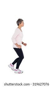 Side View Of Mature Woman Jogging Against White Background