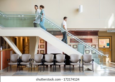 Side view of medical team and man using staircase in hospital - Powered by Shutterstock