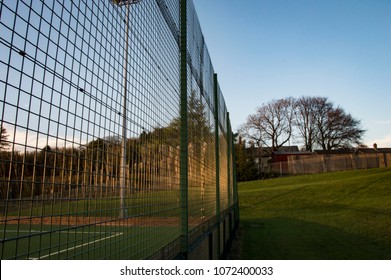 Side View Of Metal Fence Surrounding Artificial Multi-Use Pitch