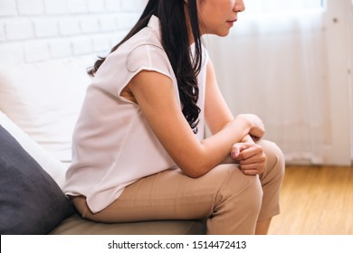 Side View Of Middle Aged Beautiful Woman Sitting Upset And Thinking About Problems Indoors