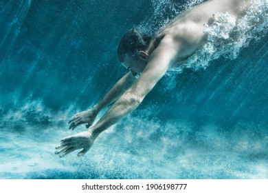 Side view of middle aged man swimming underwater - Powered by Shutterstock