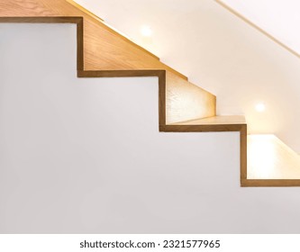 Side view modern loft, wooden staircase with lights bulb for illumination as safety protection. Minimal architecture interior design of the contemporary house. Bright space and warm construction style - Powered by Shutterstock