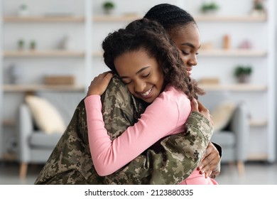 Side View Of Mom African American Woman In Military Uniform Hugging Child Happy Curly Girl Teenager At Home, Mother Came Back From Military Service, Embracing With Her Daughter, Copy Space