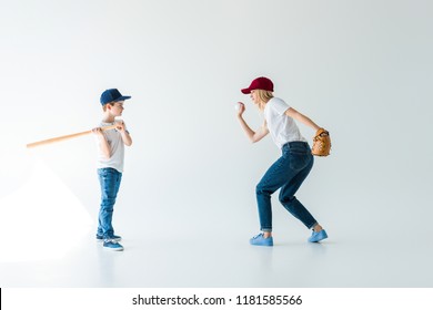 Side View Of Mommy Pitching Baseball Ball To Son With Bat Isolated On White