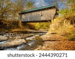 Side view of Montgomery covered bridge near Waterville in Vermont during the fall