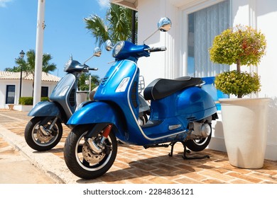 side view of moped vehicle blue color. moped vehicle outside. moped vehicle in the street.