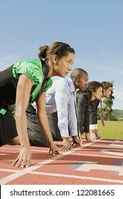 Side View Of Multi Ethnic Business People At Starting Line On Race Track