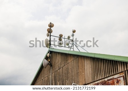 Side view of multiple communicaiton antenna on rooftop pillar mast- fixed, mobile, radionavigation-satellite radiolocation, radiolocation
