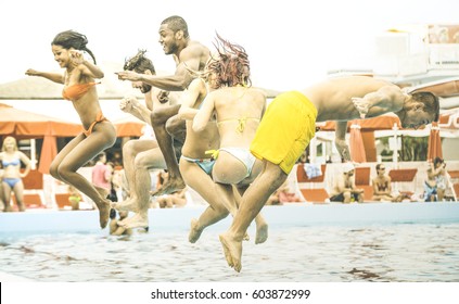 Side View Of Multiracial Friends Jumping At Swimming Pool Party - Vacation Concept With Happy Guys And Girls Having Fun In Summer Day At Leisure Aquapark - Active Young People On Retro Contrast Filter