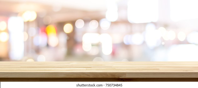 Side View Of Natural Wood Pattern Table Top Against Blurred Bright Bokeh Background In Cafe Suitable For Montage Or Display Your Products (foods)