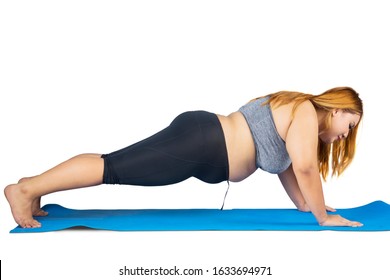 Side View Of Obese Woman Exercising By Doing Push Up On The Mat, Isolated On White Background