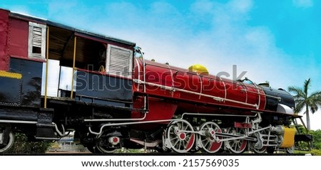 Side view of old black historic vintage british Steam Locomotive Engine at Lucknow railway station in India with beautiful architecture design and color.