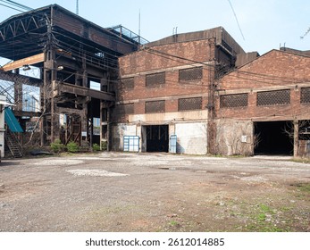 Side view of old red brick industrial factory building with windows