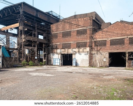 Side view of old red brick industrial factory building with windows