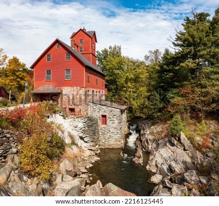 Side view of the Old Red Mill by the creek in Jericho Vermont during the fall