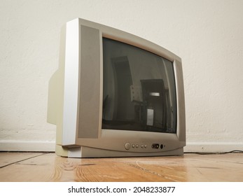 Side View Of An Old Retro TV On Wooden Ground