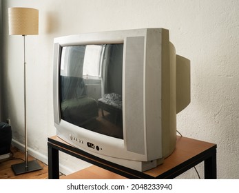 Side View Of An Old Retro TV On Wooden Table 