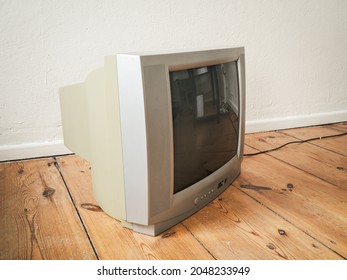 Side View Of An Old Retro TV On Wooden Ground