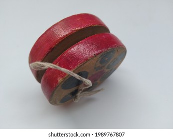 The side view of an old wooden Yoyo.