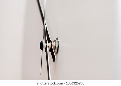 a side view on a black clock arrows, closeup
