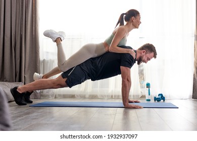 Side View On Couple Doing Push Ups Together, Woman Lying On Man's Back, Training Body, Strong Male In Good Shape, Sport Concept