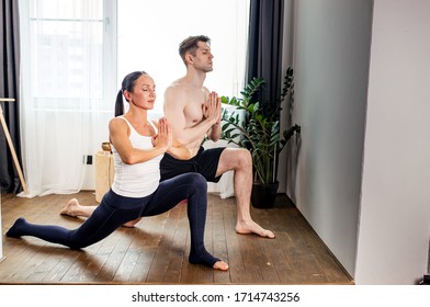 side view on couple keeping balance during yoga exercises, they keep calm while one leg stretched in back