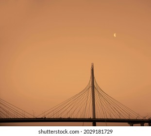 side view on road bridge at sunset with moving cars. Steel construction on a blue  sky background. cable stayed bridge. Saint Petersburg, Russia.