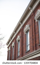Side view on the upper floors of an old brick office and apartment building, isolated on a white background