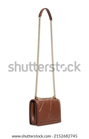 Side view on women's brown Leather bag Handbag with long chain strap Hanging Isolated on White Background