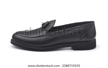 Side view of one black leather tassel loafer isolated on white