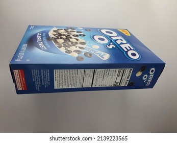 Side View Of Oreo O's Crunchy Cocoa Hoops Cereal Box. Chocolate Vanilla Flavor. O-shaped. OREO Cookie Taste. Blue Rectangular Paper Packaging. Nutritional Facts. White Background. Malaysia. March 2022