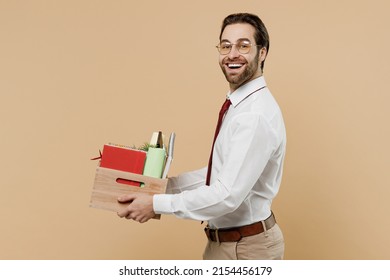 Side View Oung Dismissal Employee Business Man Corporate Lawyer In Formal White Shirt Red Tie Glasses Work In Office Hold Box With Stationery Things For Relocation Isolated On Plain Beige Background