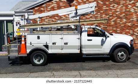 Side View Of Parked Communication Utility Truck In Residential Neighborhood. 