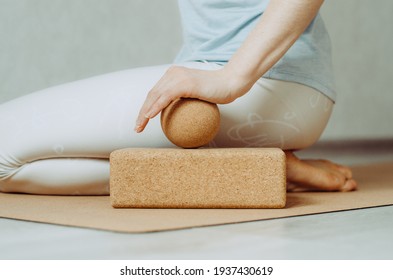 Side view of person doing palmar fascia release with a large cork ball on a cork block