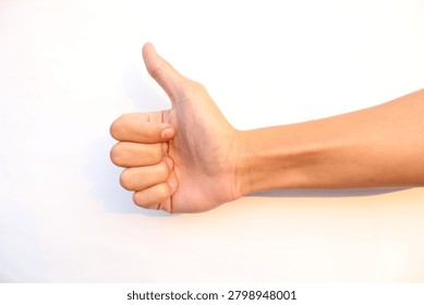 Side view of a person's hand making a thumbs-up gesture against a clean white backdrop, symbolizing success, approval, agreement, or liking something.