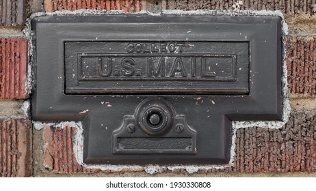 Side View Photo Of Old Vintage Mail Slot With The Words US Mail Printed On Surface.